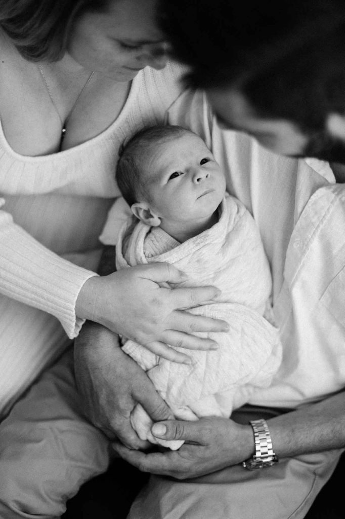 newborn baby with looking up at his dad
